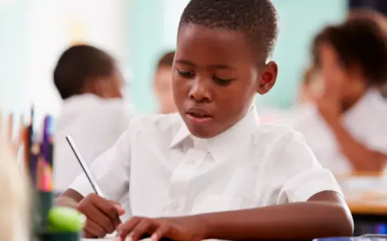 boy in class writing